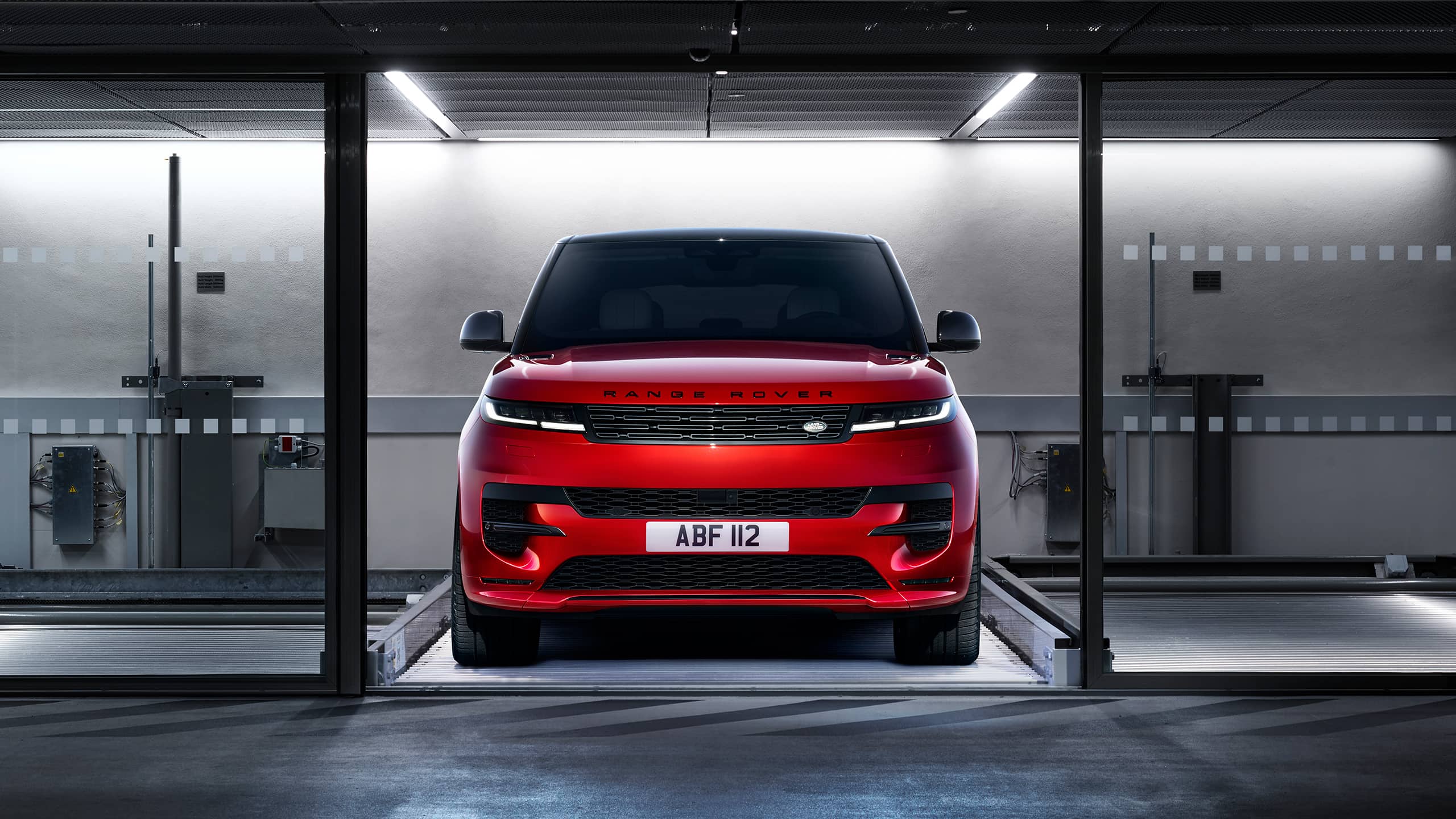 Red Range Rover Sport coming out of sliding door