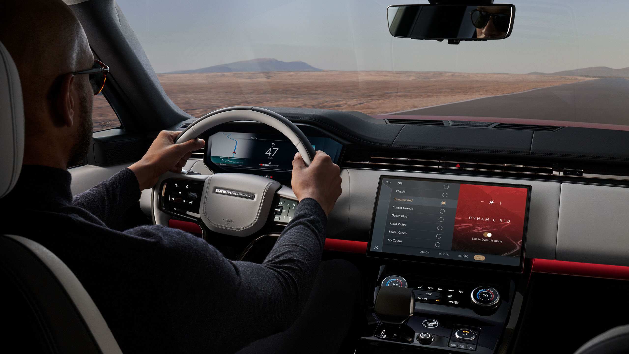 Man driving Range Rover Sport on a road